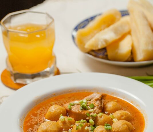 감기 걸렸을 때 피해야 할 음식과 권장 음식 A bowl of soup on a table with a glass of orange juice
