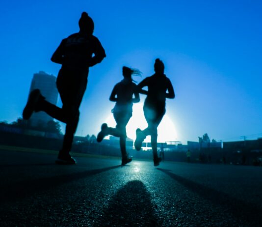 면역력 강화를 위한 운동의 역할 silhouette of three women running on grey concrete road