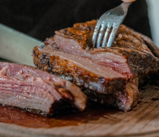 저탄고지(LCHF) 식단과 건강 논란 person slicing a meat on brown wooden board