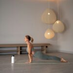 ‘마이크로 운동’, 바쁜 일상 속 건강 지키는 새로운 습관으로 떠올라 a woman doing yoga